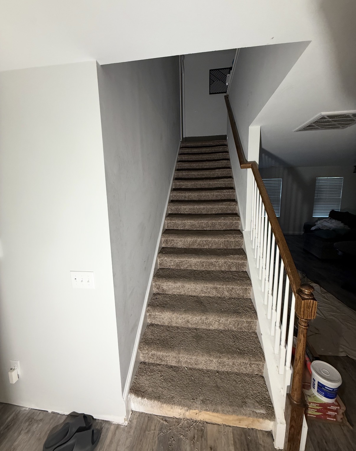 Before: Carpeted staircase leading to a landing with freshly painted neutral walls — Stairwell to Finished Living Space, Interior Painting & Flooring by CJC Remodeling