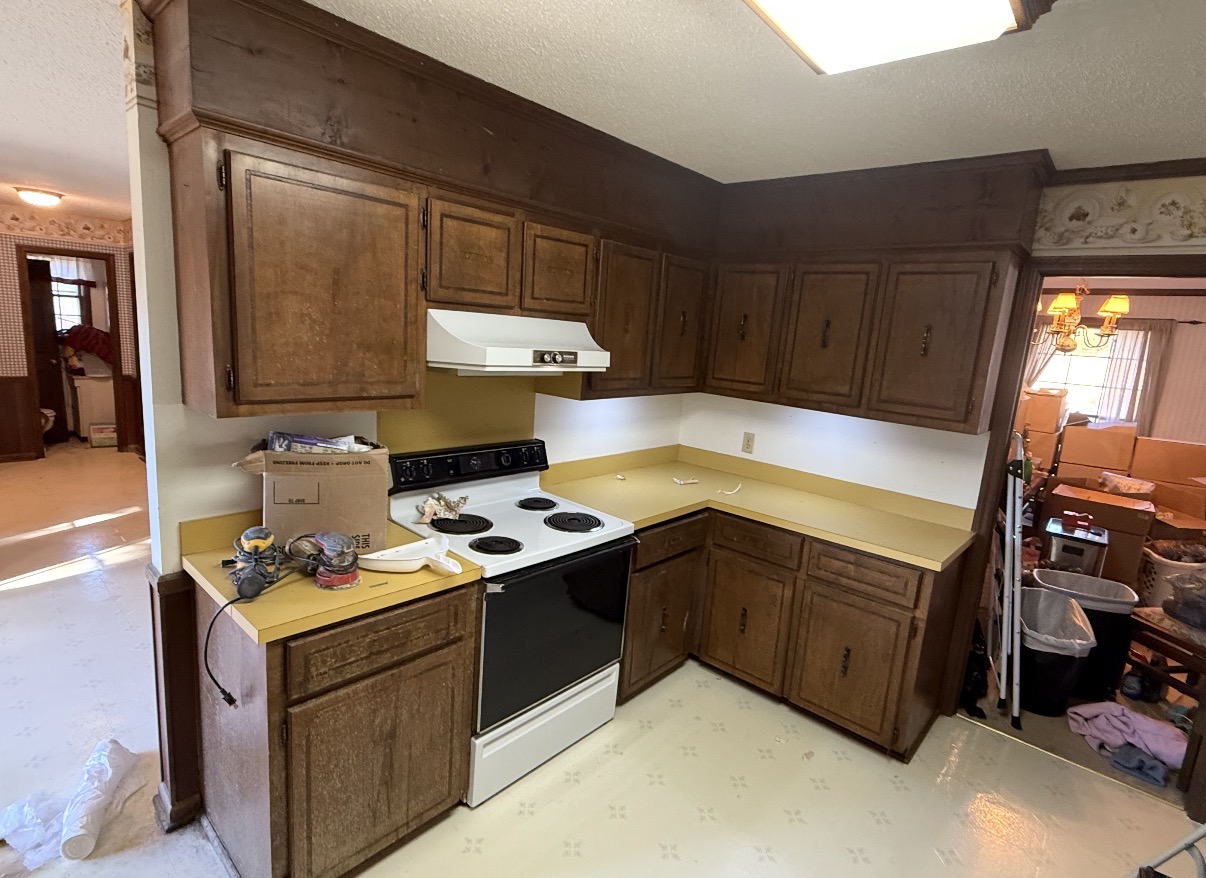 Before: Before photo of a dated kitchen with dark oak cabinets and yellow laminate countertops — Dated Oak Kitchen to Modern Blue, Cabinet Painting by CJC Remodeling