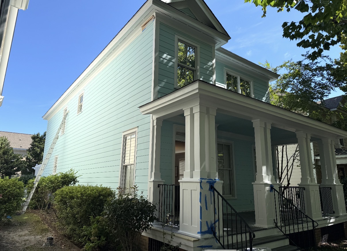 After: Completed two-story exterior repaint in soft sage green with white trim — Full Exterior Color Change, Exterior Painting by CJC Remodeling